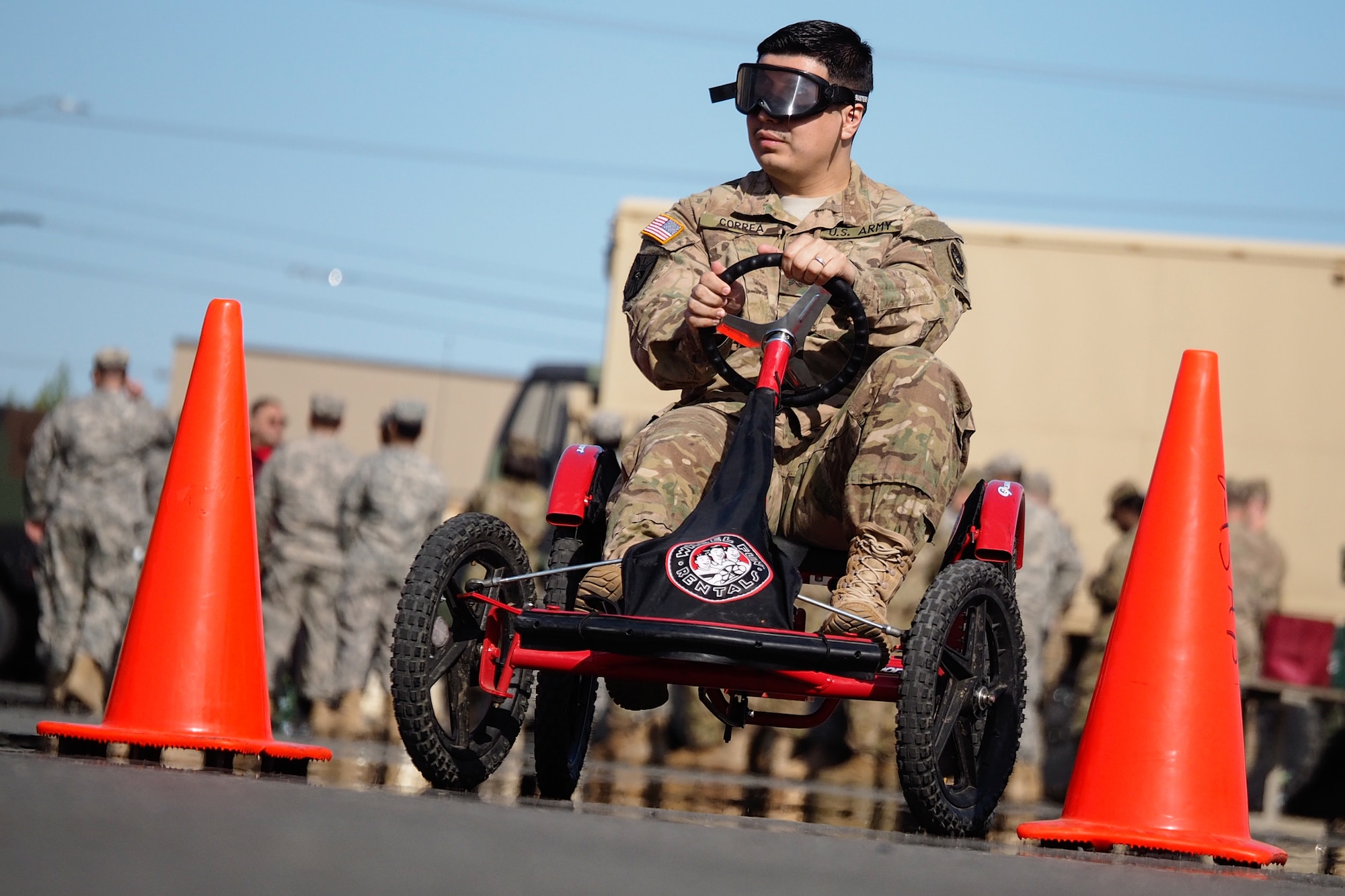 Army Sgt. Luiz Correa, a native of Beaverton, Ore., assigned to the 17th Combat Sustainment Support Battalion, U.S. Army Alaska, negotiates a driving obstacle course while wearing goggles that simulate visual impairment under the influence of alcohol during a unit Safety Stand-Down Day, Friday, May 13, 2016. During the event Soldiers were trained at different stations in fire prevention, personal weapons safety, outdoor recreation safety, family and personal health, and Driving Under the Influence prevention. (U.S. Air Force photo/Justin Connaher)