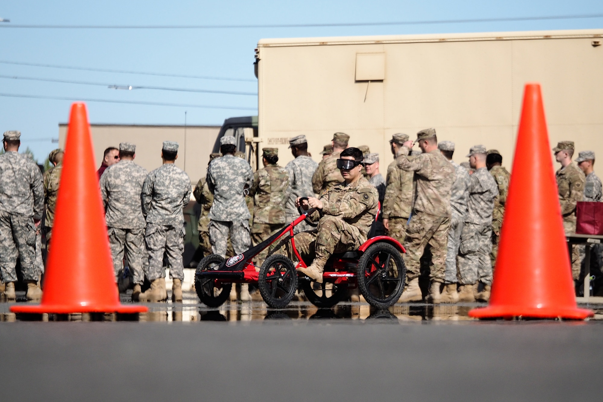 Army Sgt. Luiz Correa, a native of Beaverton, Ore., assigned to the 17th Combat Sustainment Support Battalion, U.S. Army Alaska, negotiates a driving obstacle course while wearing goggles that simulate visual impairment under the influence of alcohol during a unit Safety Stand-Down Day, Friday, May 13, 2016. During the event Soldiers were trained at different stations in fire prevention, personal weapons safety, outdoor recreation safety, family and personal health, and Driving Under the Influence prevention. (U.S. Air Force photo by Justin Connaher)