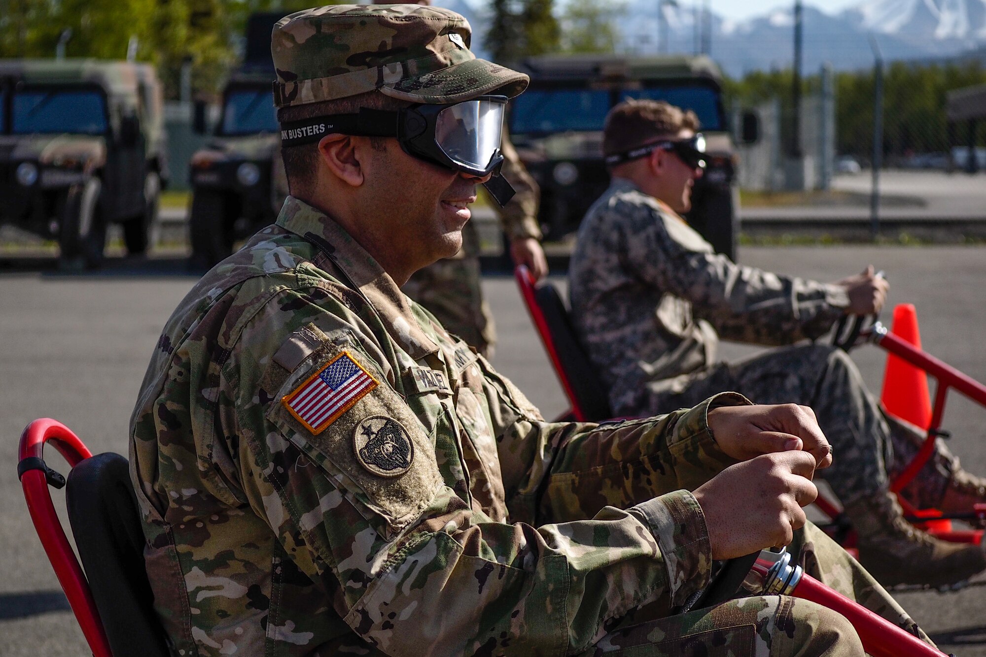 Spc. Elvin Vazquez, assigned to the 17th Combat Sustainment Support Battalion, U.S. Army Alaska, prepares to negotiate a driving obstacle course while wearing goggles that simulate visual impairment under the influence of alcohol during a unit Safety Stand-Down Day, Friday, May 13, 2016. During the event Soldiers were trained at different stations in fire prevention, personal weapons safety, outdoor recreation safety, family and personal health, and Driving Under the Influence prevention. (U.S. Air Force photo by Justin Connaher)