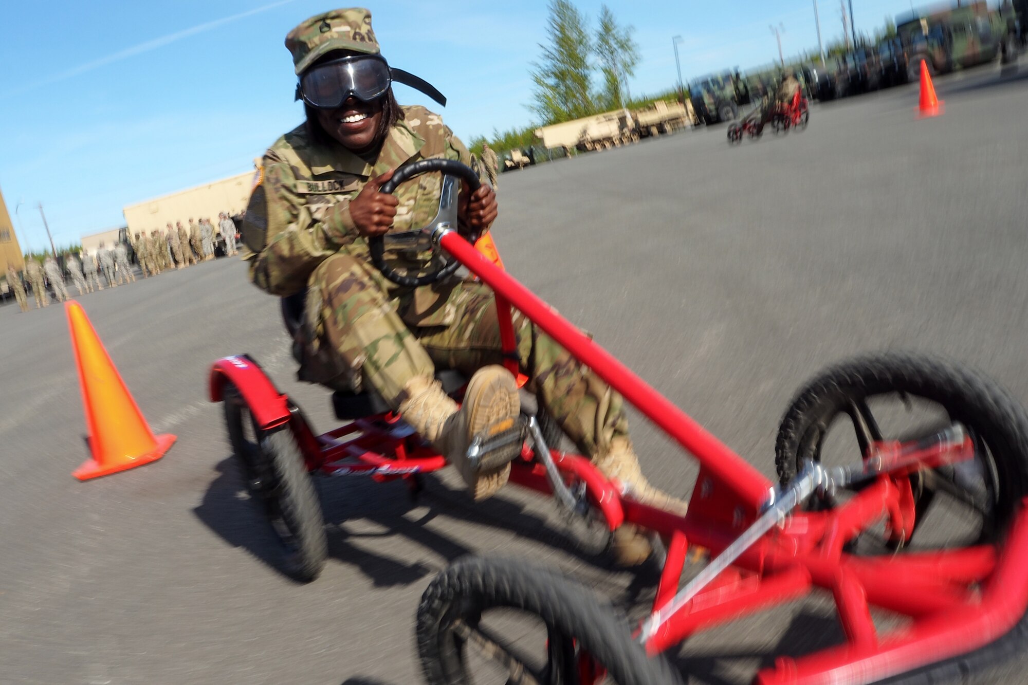 Army Staff Sgt. Chantell Bullock, a native of Bessemer, Ala., assigned to the 17th Combat Sustainment Support Battalion, U.S. Army Alaska, negotiates a driving obstacle course while wearing goggles that simulate visual impairment under the influence of alcohol during a unit Safety Stand-Down Day, Friday, May 13, 2016. During the event Soldiers were trained at different stations in fire prevention, personal weapons safety, outdoor recreation safety, family and personal health, and Driving Under the Influence prevention. (U.S. Air Force photo/Justin Connaher)