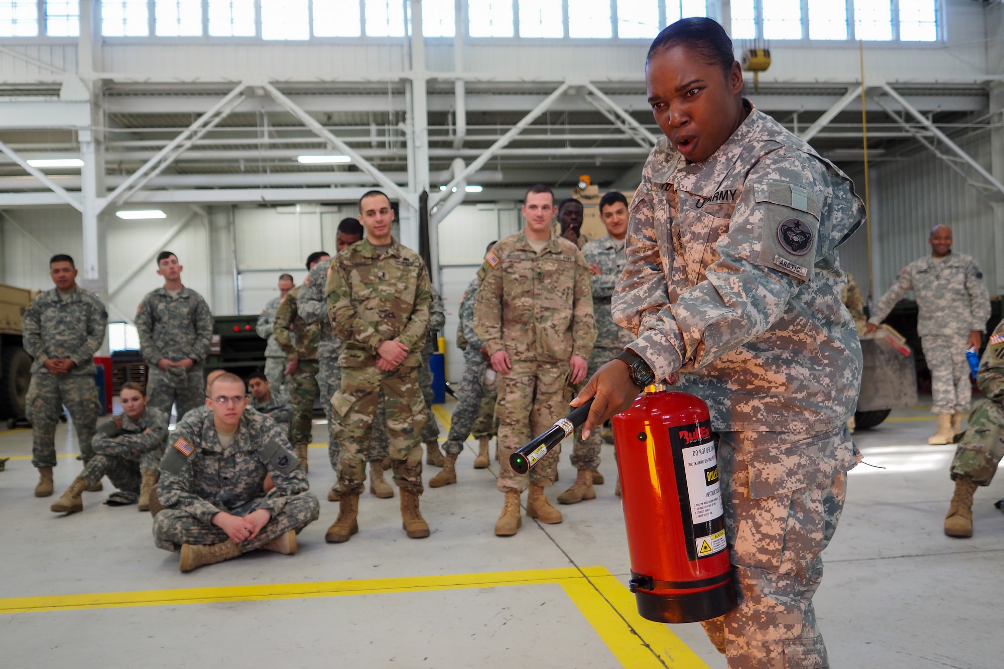 Army Master Sgt. Felicia Boyd, assigned to the 17th Combat Sustainment Support Battalion, U.S. Army Alaska, practices putting out a fire during a unit Safety Stand-Down Day, Friday, May 13, 2016. The Soldiers were trained at different stations in fire prevention, personal weapons safety, outdoor recreation safety, family and personal health, and Driving Under the Influence prevention. (U.S. Air Force photo by Justin Connaher)