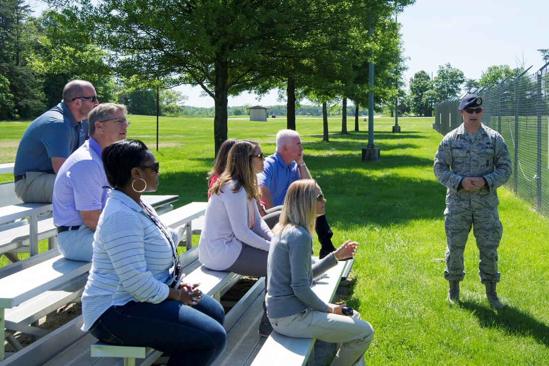 Members of the Ladies Professional Golf Association and guests watch a K-9 demonstration at the 11th Security Forces military working dog kennels on Joint Base Andrews, Md., May 20, 2016. They toured units before hosting lessons at The Courses here, May 21. (U.S. Air Force photo by Senior Airman Ryan J. Sonnier/RELEASED)