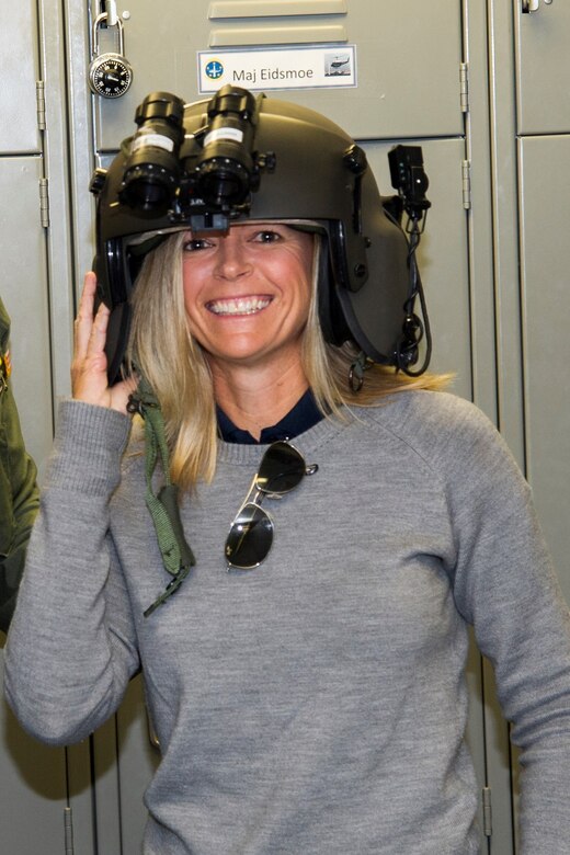 Jenny Gleason, professional golfer, tries on an aircrew helmet during a 1st Helicopter Squadron visit on Joint Base Andrews, Md., May 20, 2016. Members of the Ladies Professional Golf Association toured units before hosting lessons at The Courses here, May 21. (U.S. Air Force photo by Senior Airman Ryan J. Sonnier/RELEASED)