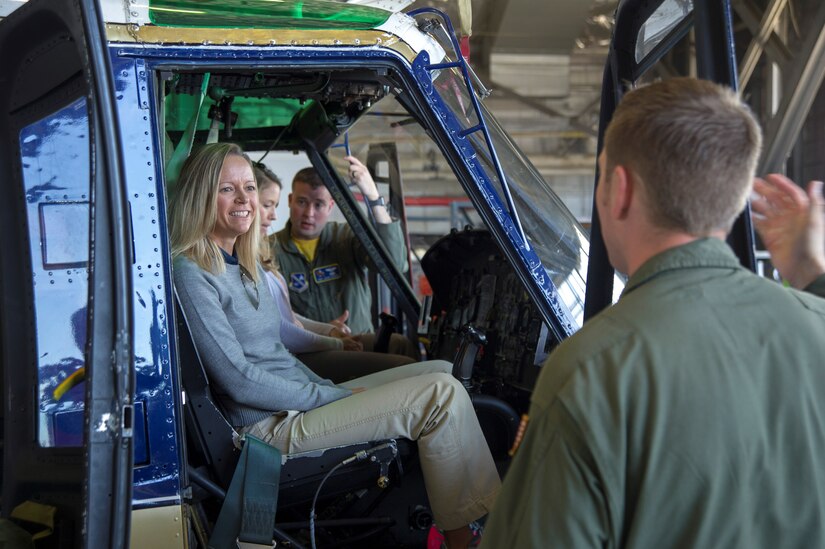 Jenny Gleason, professional golfer, sits in the pilot seat of a UH-1N Iroquois assigned to the 1st Helicopter Squadron on Joint Base Andrews, Md., May 20, 2016.  Members of the Ladies Professional Golf Association toured units before hosting lessons at The Courses here, May 21. (U.S. Air Force photo by Senior Airman Ryan J. Sonnier/RELEASED)