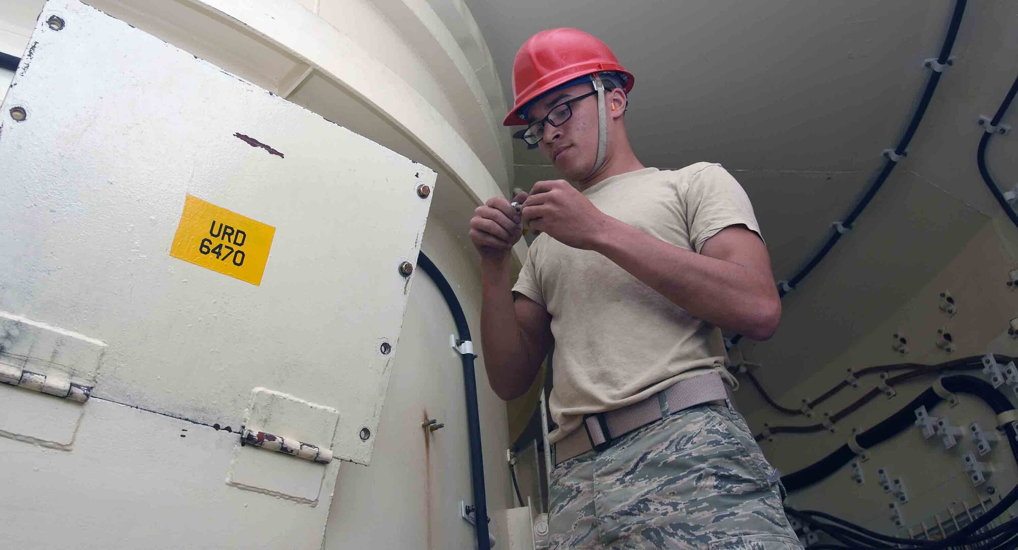 Airman First Class James Newsome, 341st Missile Maintenance Squadron member, works inside a trainer, T-9, at Malmstrom Air Force Base, Mont., May 18, 2016.  The trainer will be reconfigured over a three-year period to better reflect the configuration of current launch facilities in Malmstrom’s missile field.  (U.S. Air Force photo/Senior Airman Jaeda Tookes)