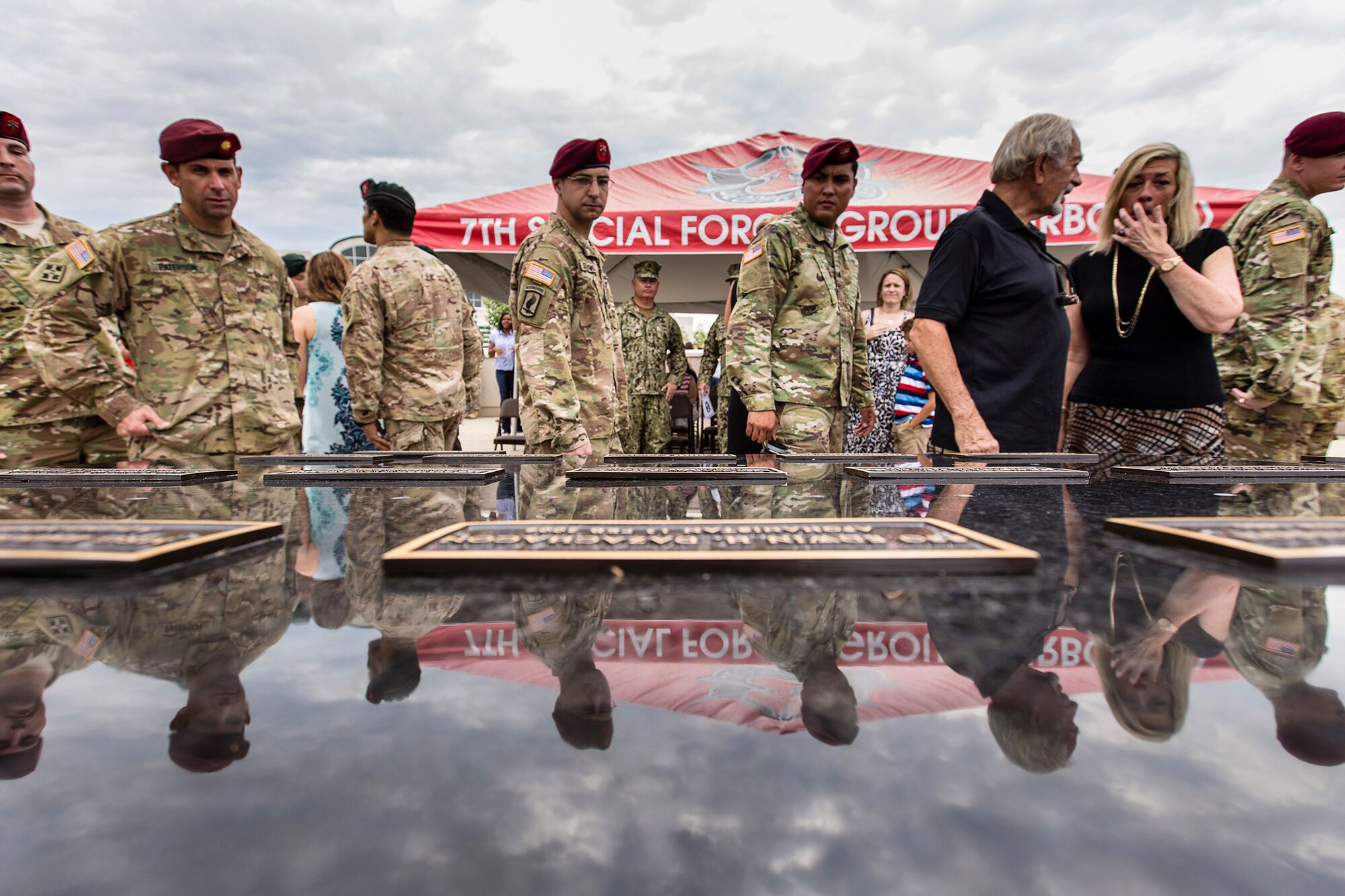 Soldiers assigned to the 7th Special Forces Group (Airborne) pay their respects to the fallen during the unit's memorial wall dedication ceremony held on Eglin Air Force Base Fla, May 17. The wall lists the names of 58 Soldiers who made the ultimate sacrifice while assigned to the 7th Special Forces Group from the Vietnam War to the present. (U.S. Army photo by Staff Sgt. Bryan Henson)