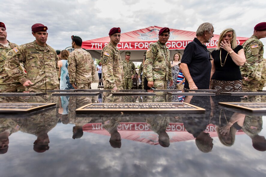 Soldiers assigned to the 7th Special Forces Group (Airborne) pay their respects to the fallen during the unit's memorial wall dedication ceremony held on Eglin Air Force Base Fla, May 17. The wall lists the names of 58 Soldiers who made the ultimate sacrifice while assigned to the 7th Special Forces Group from the Vietnam War to the present. (U.S. Army photo by Staff Sgt. Bryan Henson)