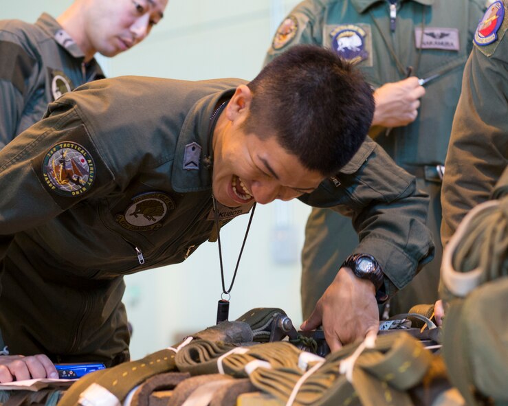 Japan Air Self-Defense Force Staff Sgt. Daichi Kubota, 401st Squadron C-130H loadmaster, performs a joint airdrop inspection at Yokota Air Base, Japan, May 18, 2016. Members of JASDF familiarized JAI procedures in preparation to drop USAF’s heavy equipment and high-velocity container delivery systems during the exercise Red-Flag Alaska. (U.S. Air Force photo by Yasuo Osakabe/Released)  