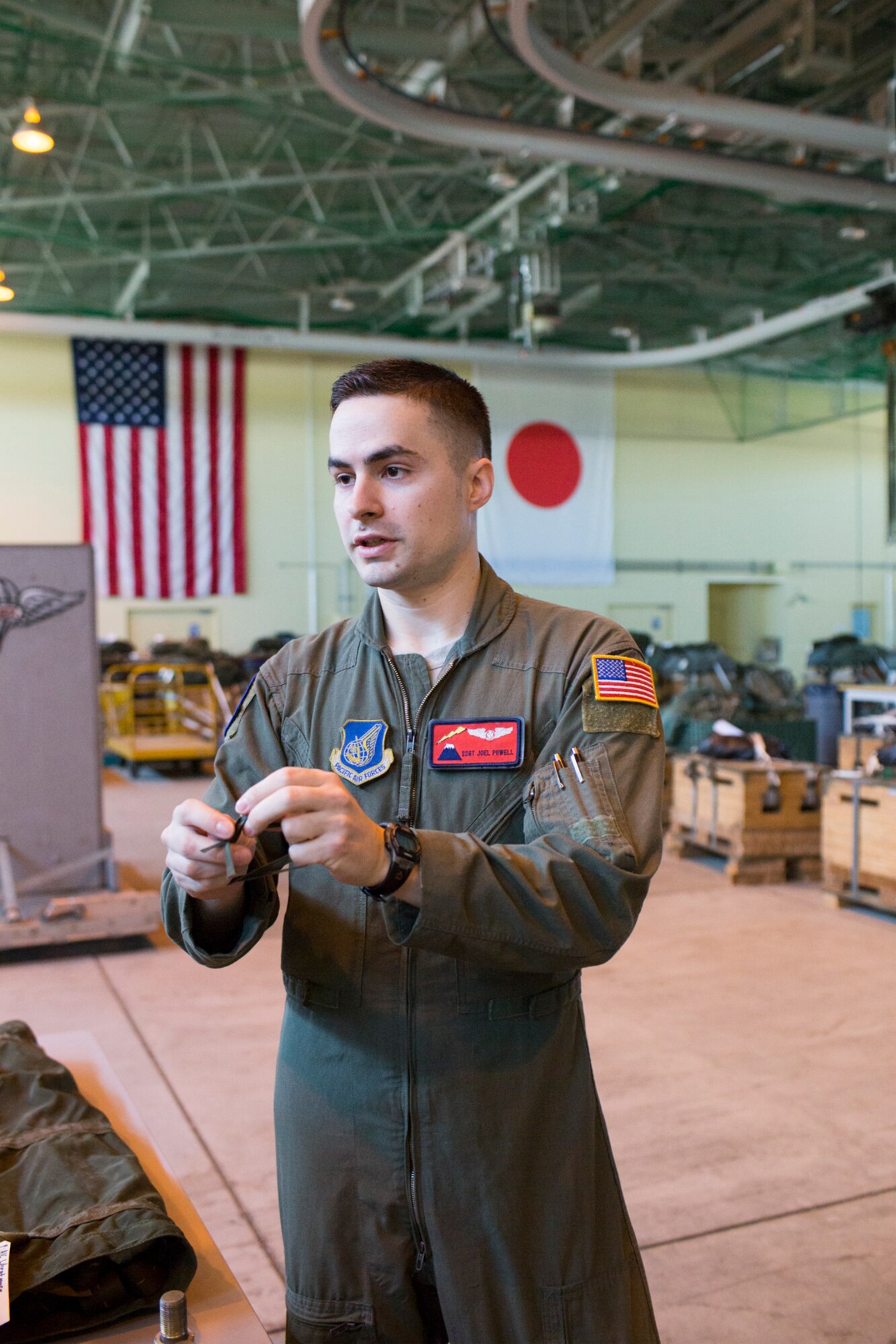 Staff Sgt. Joel Powell, 374th Operations Support Squadron joint airdrop inspector, demonstrates rope work during joint airdrop inspection familiarization for Japan Air Self-Defense Force loadmasters with the 401st Squadron at Yokota Air Base, Japan, May 18. Members with the JASDF familiarized with JAI procedures to prepare for heavy equipment and high-velocity container delivery systems during the upcoming Red-Flag Alaska. (U.S. Air Force photo by Yasuo Osakabe/Released)  