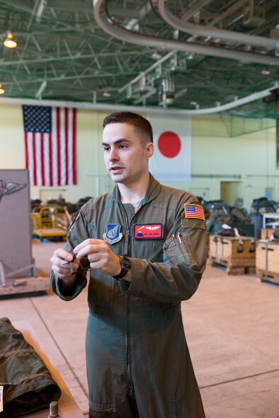 Staff Sgt. Joel Powell, 374th Operations Support Squadron joint airdrop inspector, demonstrates rope work during joint airdrop inspection familiarization for Japan Air Self-Defense Force loadmasters with the 401st Squadron at Yokota Air Base, Japan, May 18. Members with the JASDF familiarized with JAI procedures to prepare for heavy equipment and high-velocity container delivery systems during the upcoming Red-Flag Alaska. (U.S. Air Force photo by Yasuo Osakabe/Released)  