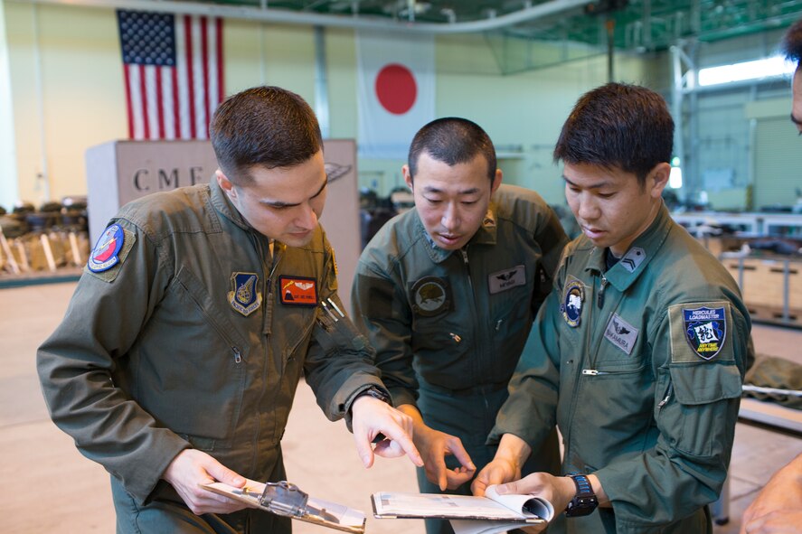 U.S. Air Force Staff Sgt. Joel Powell, 374th Operations Support Squadron joint airdrop inspector, checks Japan Air Self-Defense Force’s joint airdrop inspection checklist at Yokota Air Base, Japan, May 18, 2016. Members with the JASDF familiarized with JAI procedures to prepare for heavy equipment and high-velocity container delivery systems during the upcoming Red-Flag Alaska. (U.S. Air Force photo by Yasuo Osakabe/Released)  