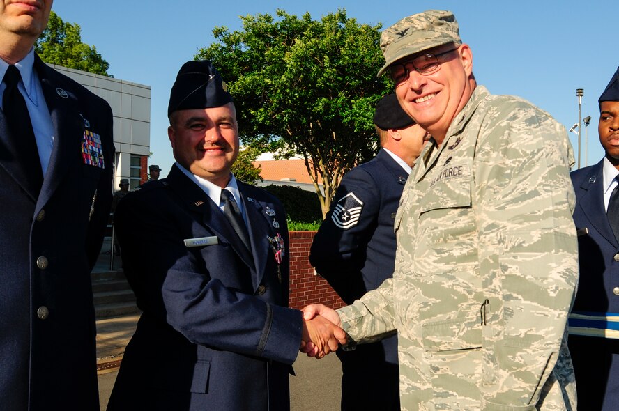 U.S. Air Force Col. Marshall C. Collins, commander, 145th Airlift Wing, awards Maj. Timothy Howard, 145th Logistics Readiness Squadron, with the Meritorious Service Medal during a ramp formation held at the North Carolina Air National Guard Base, Charlotte Douglas International Airport, May 15, 2016. Howard distinguished himself through the management of aircraft fuel which enabled 1200 sorties annually between 2010 and 2015. (U.S. Air National Guard photo by Staff Sgt. Julianne M. Showalter/Released)