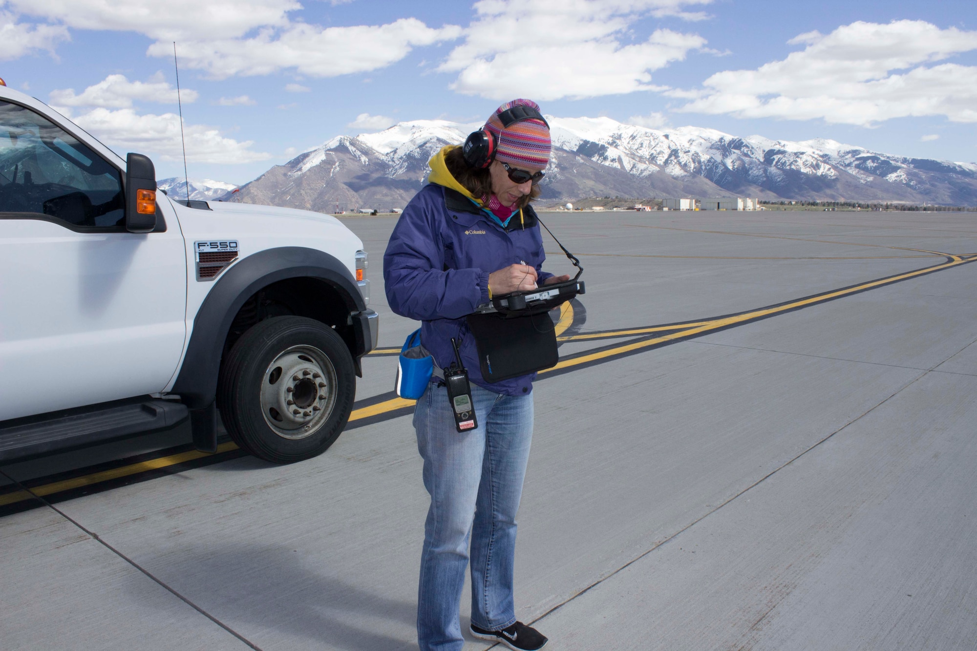Kristin Filler, pavement condition inspector for the Air Force Civil Engineer Center Airfield Pavement Evaluation, or APE, Team, conducts inspection marking distresses on the airfield at Hill AFB, Utah.