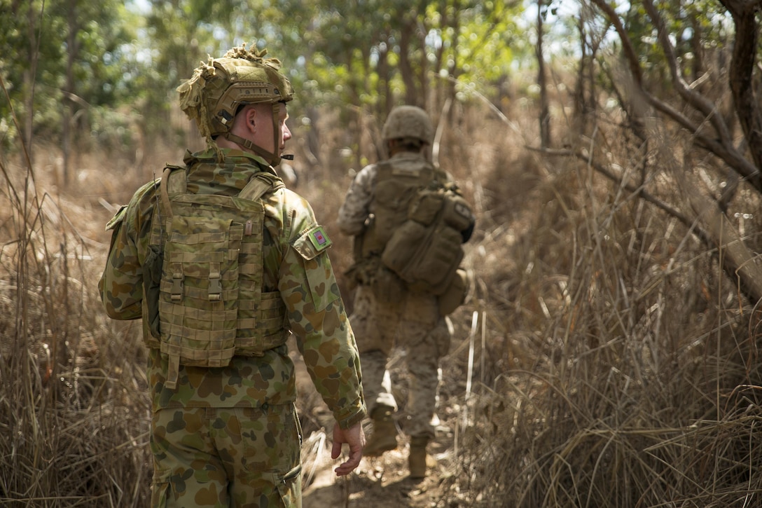 Australian Army Pvt. Jacob Handley, combat engineer, searches through the thicket with U.S. Marines at Hidden Valley Motor Sports Complex, Northern Territory, Australia, on May 19, 2016. U.S. Marine and Australian Army combat engineers conducted clearing training to find improvised explosive device and caches. Marine Rotational Force - Darwin is a six-month deployment of Marines into Darwin, Australia, where they will conduct exercises and train with the Australian Defence Forces, strengthening the U.S.-Australia alliance. Handley is with 1st Combat Engineer Regiment, 1st Brigade.