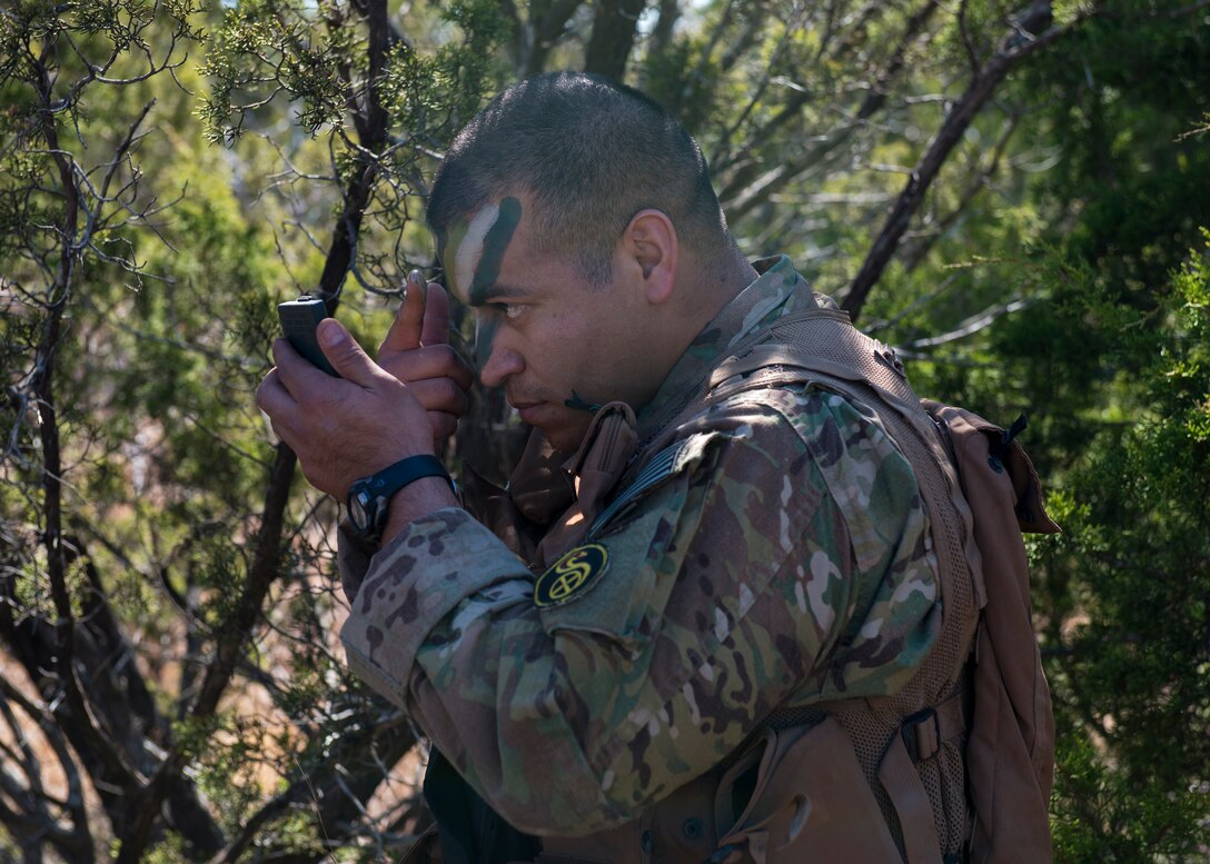 U.S. Air Force Tech. Sgt. David Noriega, 7th Operations Support Squadron Survival Evasion Resistance Escape specialist, covers his face with camouflage paint during a combat survival course training, Feb. 18, 2016, in Abilene, Texas. Noriega used this tactic to show aircrew students the significance of blending in with the environment in attempts to evade and avoid capture in enemy territory. (U.S. Air Force photo by Airman 1st Class Katherine Miller/Released)