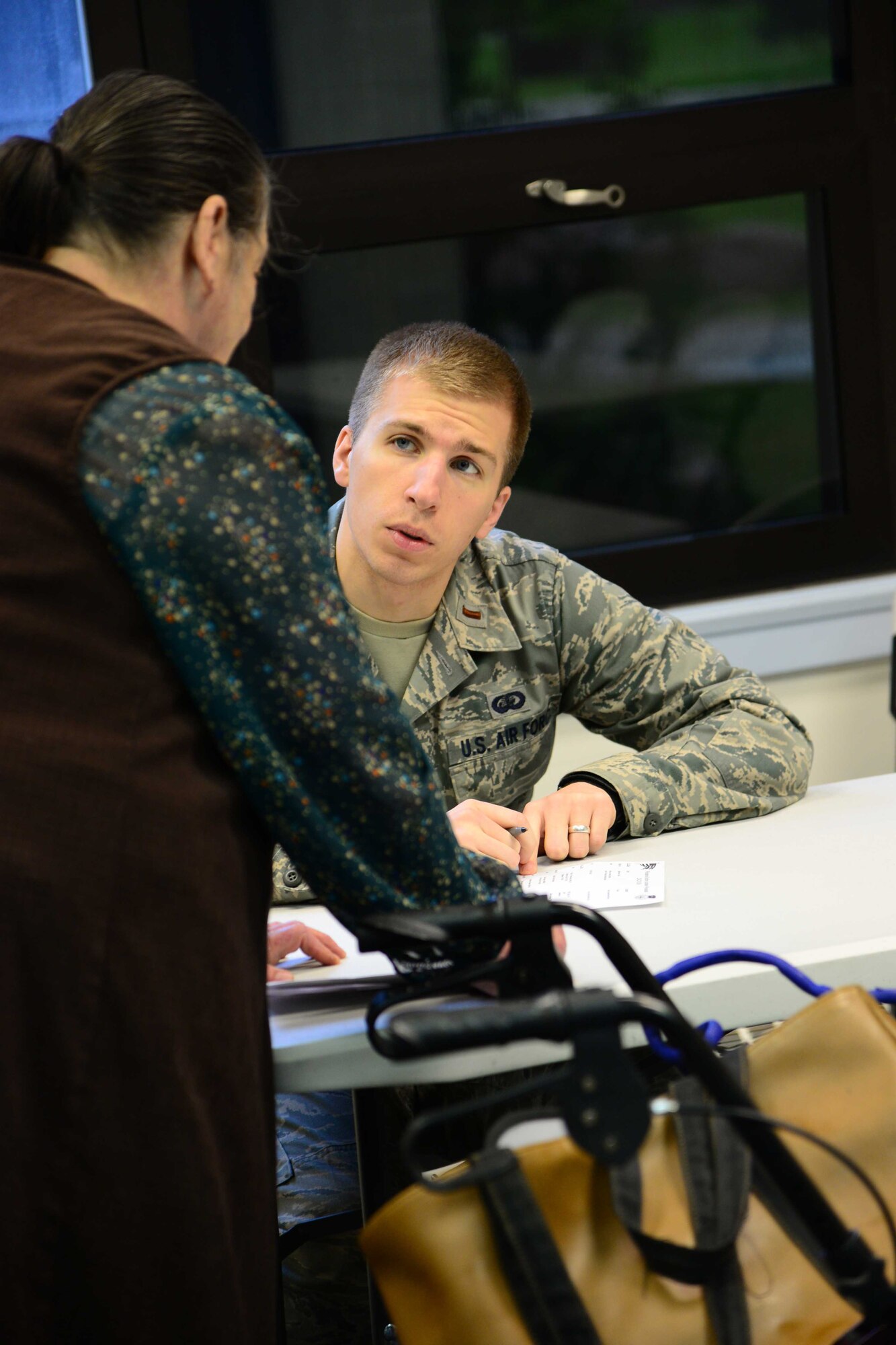 2nd Lt. Mark Howell, 341st Force Support Squadron, answers a question during an information fair May 21, 2016, at Malmstrom Air Force Base, Mont. The 341st Missile Wing held the fair for retirees and their dependents to ask questions and receive answers about their benefits during retirees appreciation weekend. (U.S. Air Force photo/Airman 1st Class Magen M. Reeves)