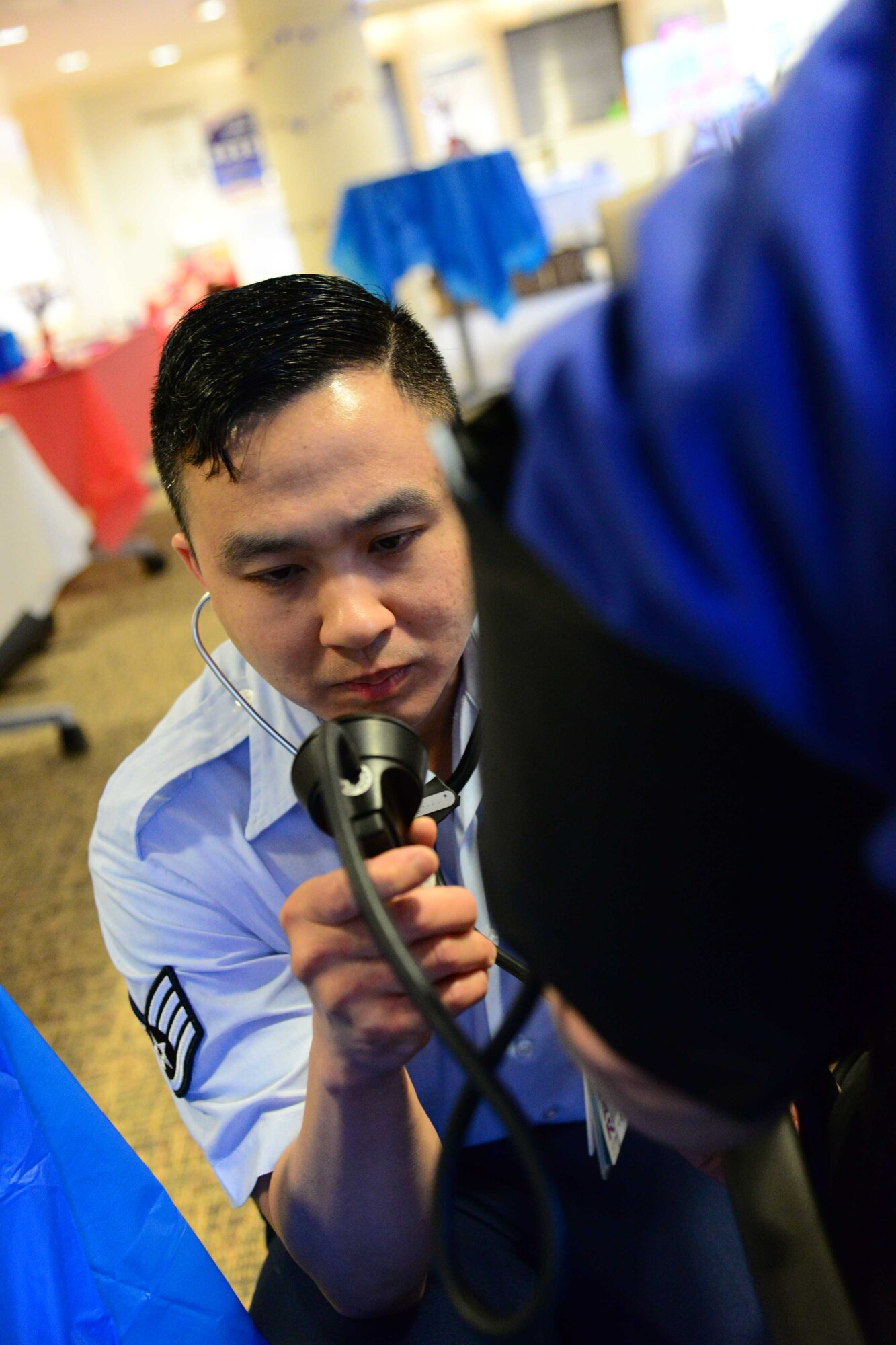 Staff Sgt. Owen Wijaya, 341st Medical Operations Squadron medical technician, checks a patient May 21, 2016, at Malmstrom Air Force Base, Mont. The 341st Medical Group offered several services to retirees and their dependents in honor of retirees appreciation weekend. (U.S. Air Force photo/Airman 1st Class Magen M. Reeves)