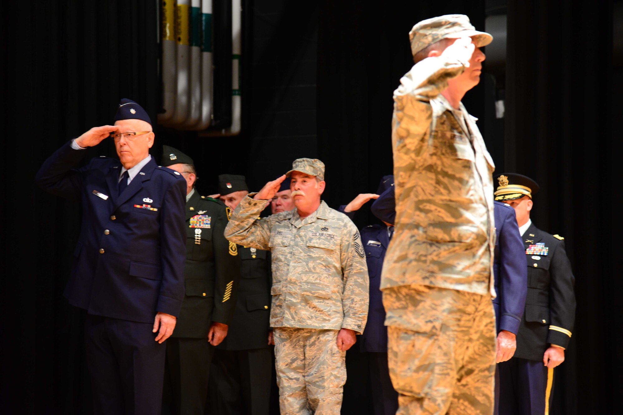 Participants in formation salute during a flag folding ceremony May 20, 2016, at Malmstrom Air Force Base, Mont. The 341st Missile Wing held a ceremony in honor of retirees appreciation weekend. (U.S. Air Force photo/Airman 1st Class Magen M. Reeves)