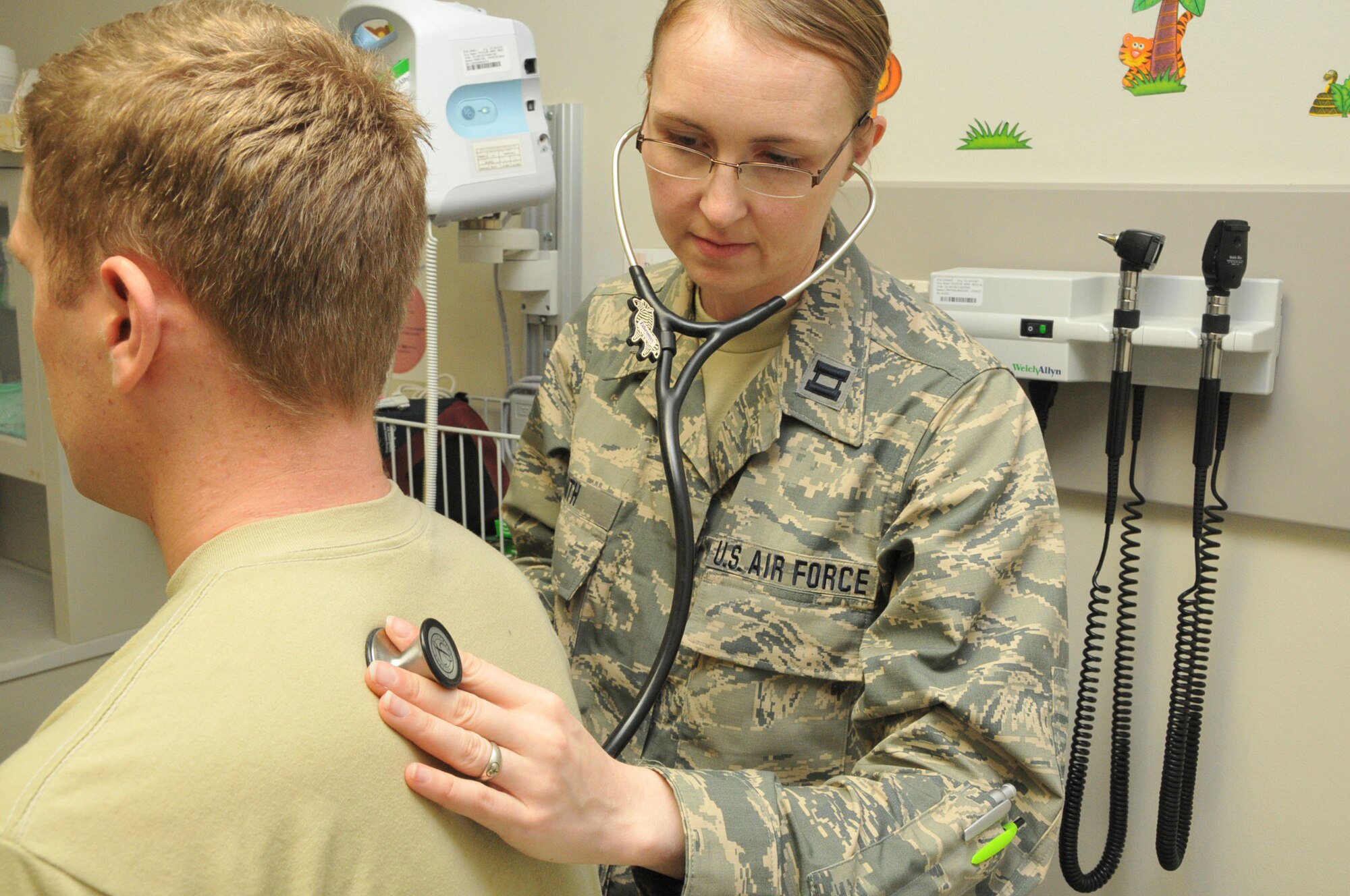 HONOLULU,HAWAII - Capt. Gwen Smith, 114th Medical Group physicians assistance, listens to a patients breath sounds during a training session at Tripler Army Medical Center (TAMC) Hawaii May 17, 2016.  Smith and 37 other Airmen with the 114th MDG are training, as well as helping to relieve the work load, at TAMC.  (U.S. Air National Guard photo by Master Sgt. Christopher Stewart/Released)