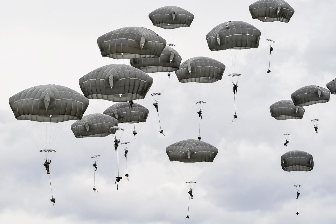 Soldiers descend over Malemute drop zone during airborne training at Joint Base Elmendorf-Richardson, Alaska, May 19, 2016. The soldiers are paratroopers assigned to the 25th Infantry Division's 4th Infantry Brigade Combat Team (Airborne). Air Force photo by Alejandro Pena