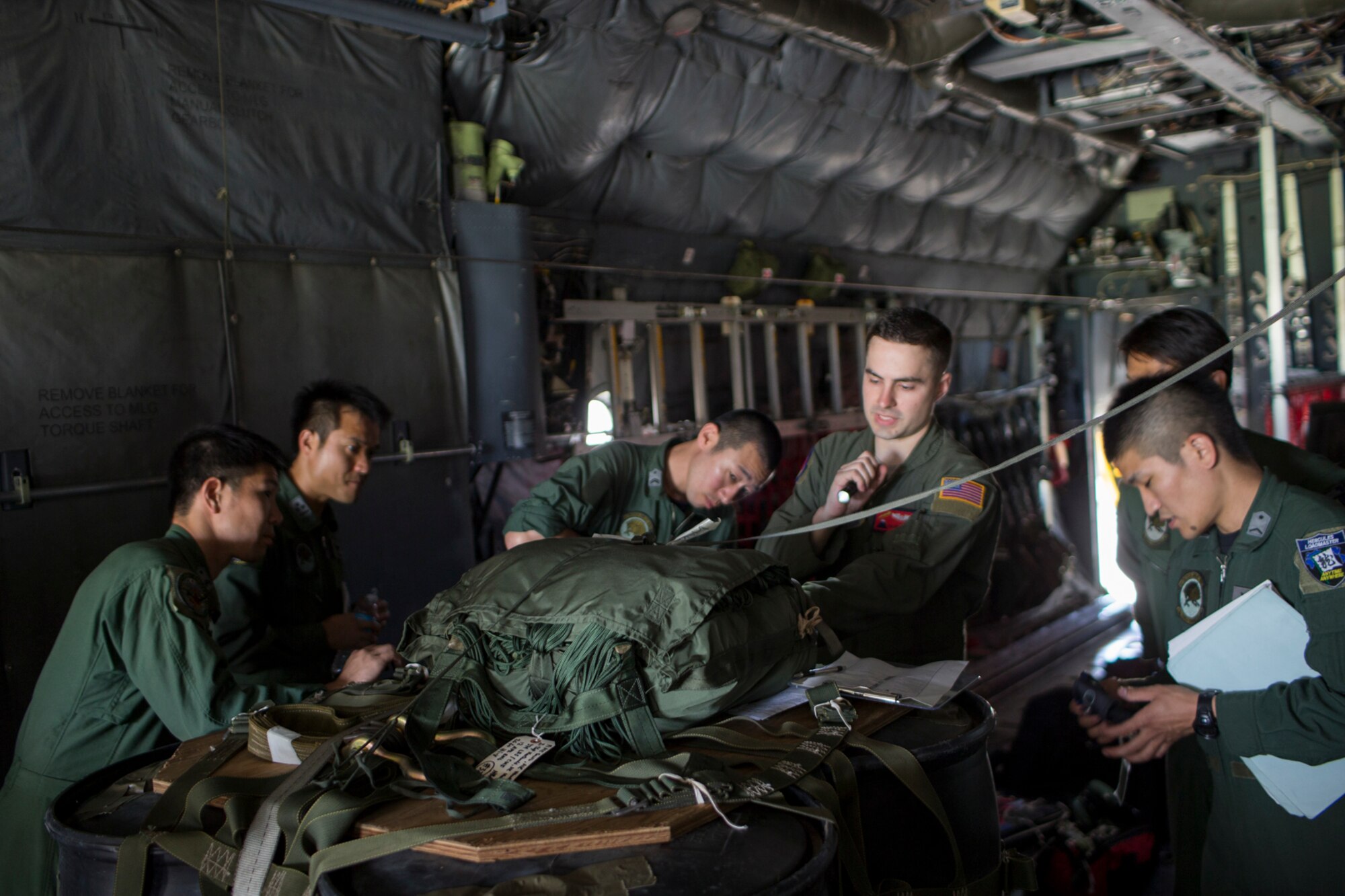 U.S. Air Force Staff Sgt. Joel Powell, 374th Operations Support Squadron joint airdrop inspector, demonstrates joint airdrop cargo inspection procedures to Japan Air Self-Defense Force members after loading heavy equipment onto a USAF C-130H Hercules at Yokota Air Base, Japan, May 18, 2016. Members of JASDF familiarized with JAI procedures in preparation to drop USAF’s heavy equipment and high-velocity container delivery systems during exercise Red-Flag Alaska. (U.S. Air Force photo by Yasuo Osakabe/Released)