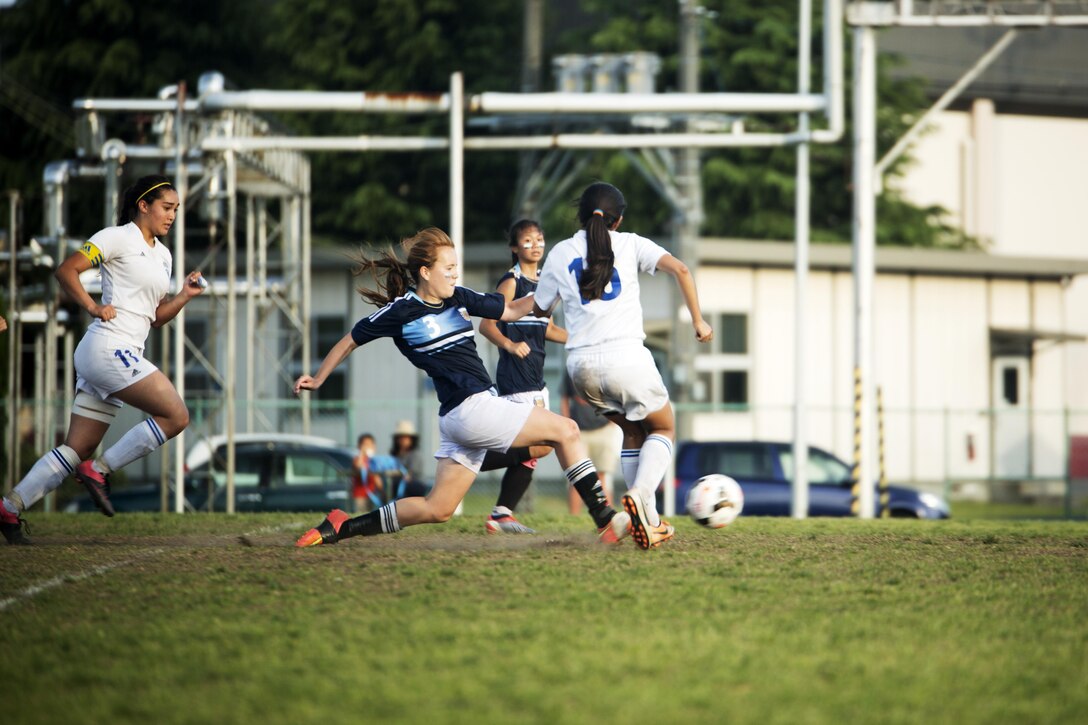 Players from the Osan Cougars and Yokota Panthers girls’ soccer teams attempt to gain possession of the ball during the championship game in the Far East Soccer Tournament hosted by Matthew C. Perry High School at Marine Corps Air Station Iwakuni May 19, 2016. The Far East Soccer Tournament is the largest soccer event that Department of Defense Education Activity Schools Pacific in Japan, Korea and International Schools have to look forward to compete in all season. (U.S. Marine Corps photo by Lance Cpl. Donato Maffin/Released)