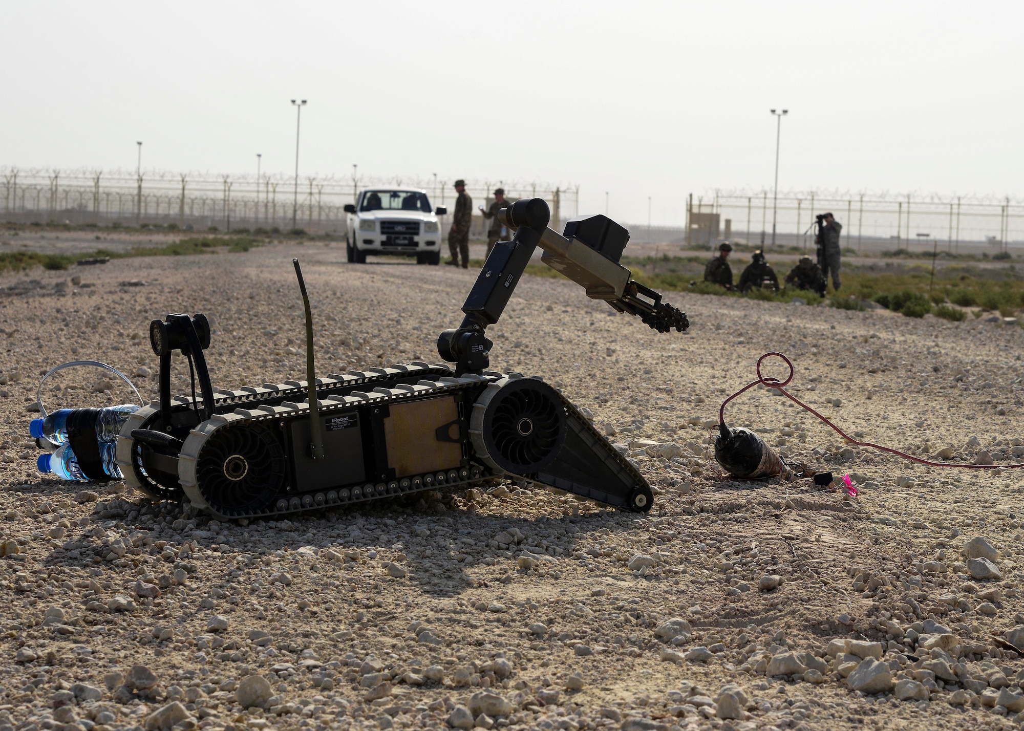 A Packbot 310 robot engages an improvised explosive device during a training exercise May 19, 2016, at Al Udeid Air Base, Qatar. Conducting training at Al Udeid AB is more realistic due to equipment availability and natural environmental situations, such as the hot desert weather. (U.S. Air Force photo/Senior Airman Janelle Patiño/Released)