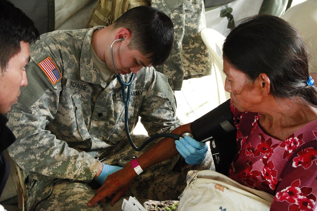 Army Spc. Joshua Towne checks a patient's blood pressure during Beyond the Horizon 2016 in San Padro, Guatemala, May 16, 2016. Towne is assigned to the 396th Combat Support Hospital Company. Army photo by Spc. Kelson Brooks