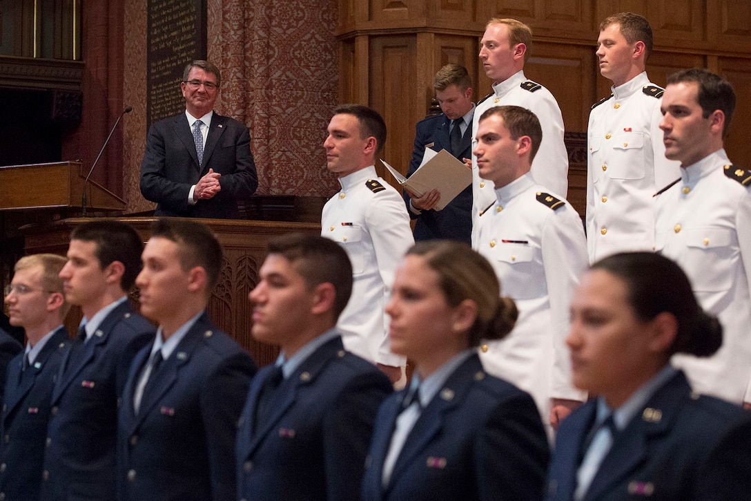 Defense Secretary Ash Carter applauds newly commissioned officers after administering the oath of office to Air Force and Naval Reserve Officers' Training Corps students during a commissioning ceremony at Yale University in New Haven, Conn., May 23, 2016. DoD photo by Air Force Senior Master Sgt. Adrian Cadiz