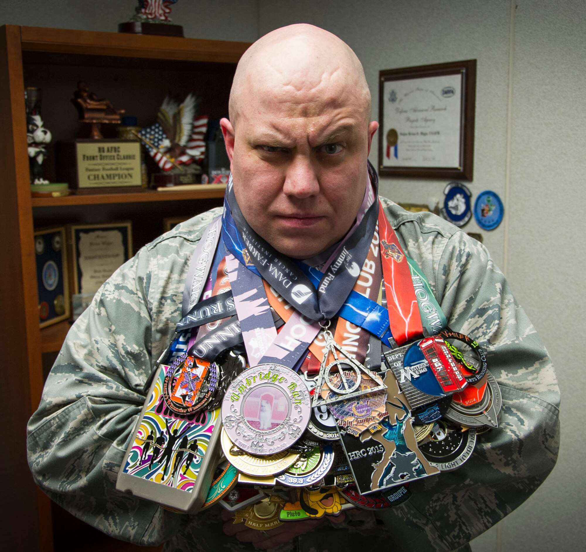 Lt. Col. Brian Biggs displays all of the medals he has received from participating in various running events throughout the country. (Matt Ebarb)