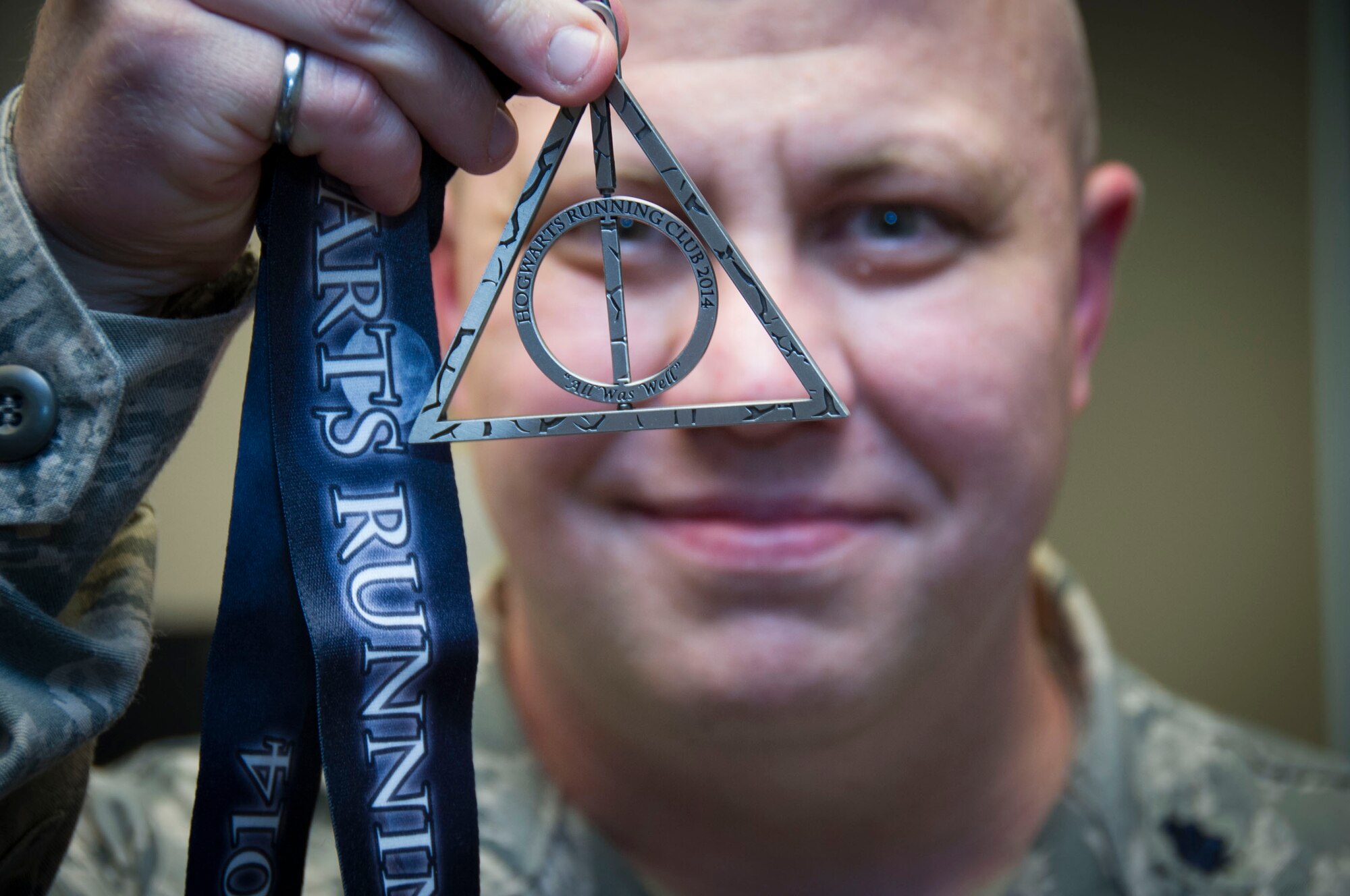 Biggs shows off one of the Hogwarts Running Club medals. (Matt Ebarb)
