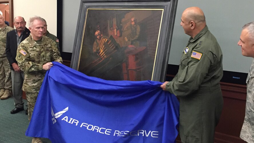 Gen. Raymond A. Thomas, III, left, U.S. Special Operations Command commander, and Maj. Gen. Richard S. "Beef" Haddad, Air Force Reserve Command vice commander, unveil a painting honoring Citizen Airmen manning the 40mm Bofors gun aboard an AC-130 gunship during a mission over the "Highway of Death" in Kuwait during Desert Storm. The painting by Maj. Warren Neary (far right), was accepted by Thomas, U.S. Special Operations Command commander, during a special ceremony at USSOCOM headquarters at MacDill Air Force Base, Florida, May 23, commemorating the 25th anniversary of Desert Storm. Haddad was an AC-130 gunship pilot with the Air Force Reserve's 919th Special Operations Wing, Duke Field, Florida, during Desert Storm. (U.S. Air Force photo/Lt. Col. Chad Gibson)