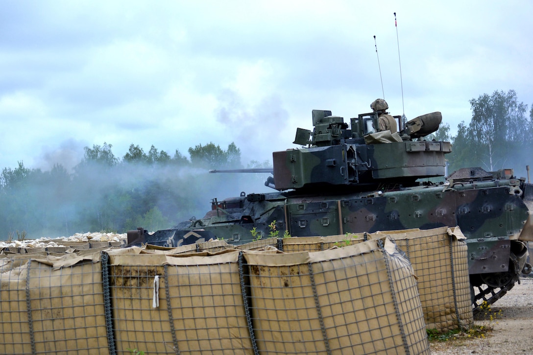 An M2A3 Bradley fighting vehicle engages targets with a 25mm cannon during a platoon’s Gunnery Table XII at Grafenwoehr Training Area, Germany, May 19, 2016. Army photo by Maj. Randy Ready