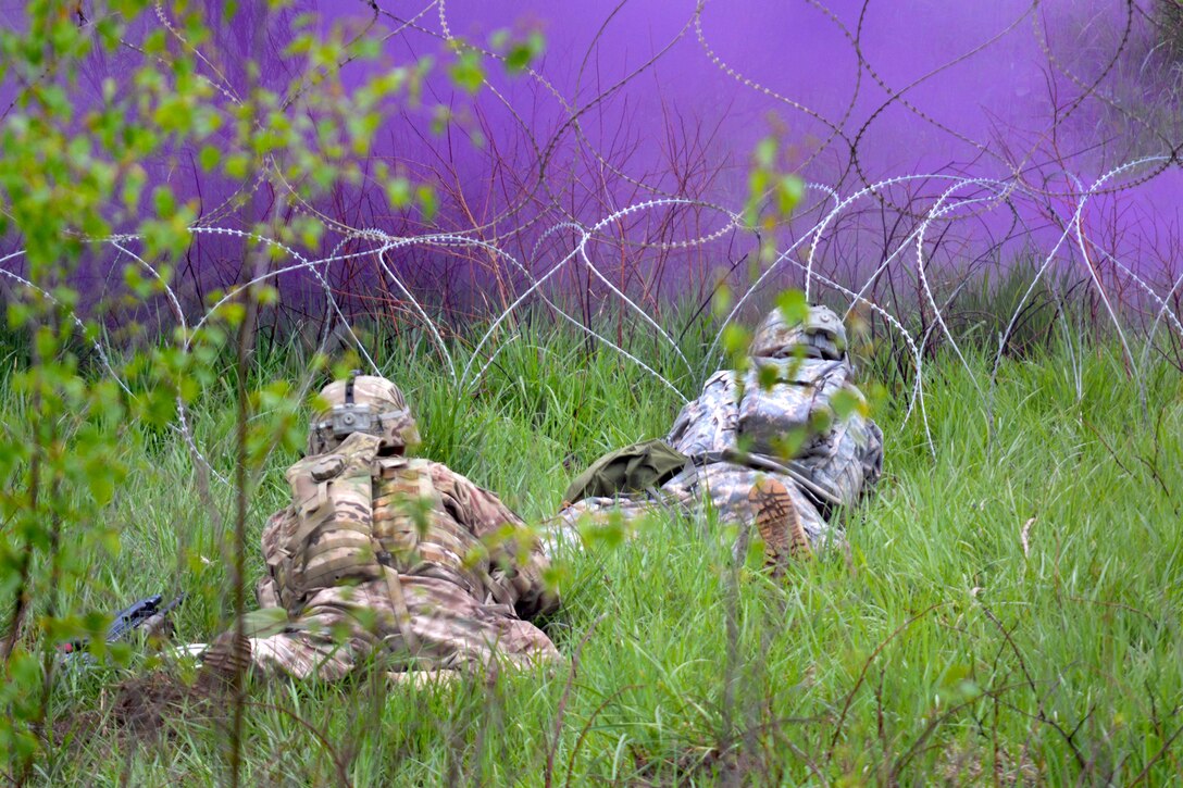 Soldiers assess a wire obstacle under the cover of smoke during their Gunnery Table XII at Grafenwoehr Training Area, Germany, May 19, 2016. The soldiers are combat engineers assigned to the 3rd Infantry Division’s 10th Engineer Battalion, 1st Armored Brigade Combat Team. Army photo by Maj. Randy Ready
