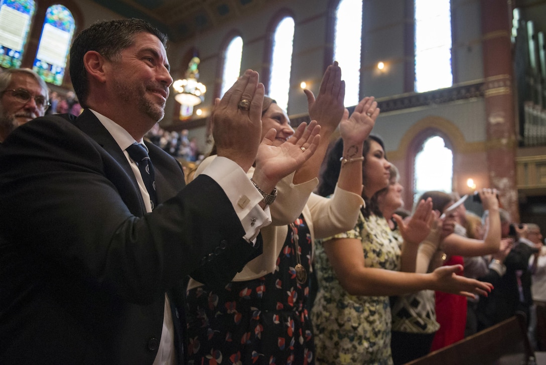 Audience members applaud after Air Force and Navy ROTC students take the oath of office during a commissioning ceremony at Yale University in New Haven, Conn., May 23, 2016. DoD photo by Air Force Senior Master Sgt. Adrian Cadiz 
