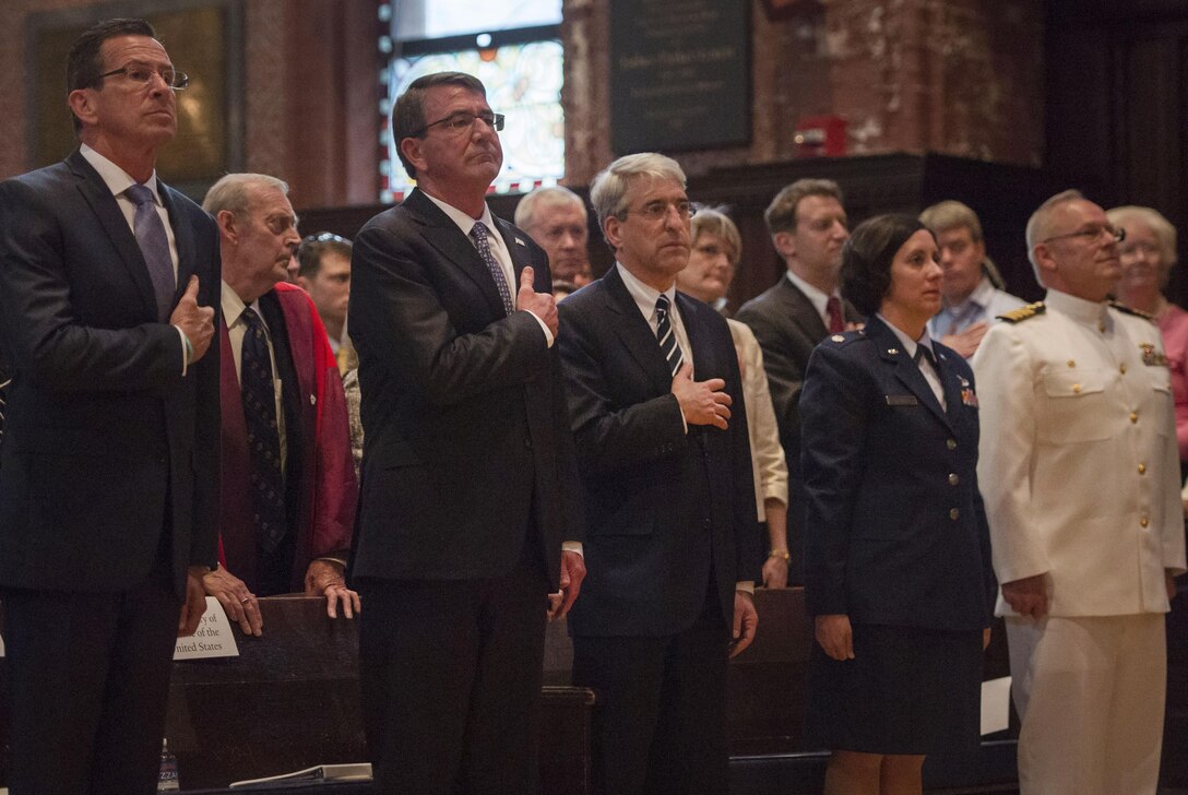 Defense Secretary Ash Carter, second from left, and Yale University President Peter Salovey render honors during the playing of the national anthem before the ROTC commissioning ceremony at Yale University in New Haven, Conn., May 23, 2016. DoD photo by Air Force Senior Master Sgt. Adrian Cadiz