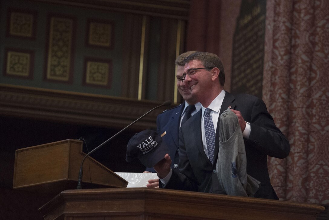 Defense Secretary Ash Carter receives a hat and shirt after delivering remarks at a commissioning ceremony for Air Force and Navy ROTC students at Yale University in New Haven, Conn., May 23, 2016. DoD photo by Air Force Senior Master Sgt. Adrian Cadiz 