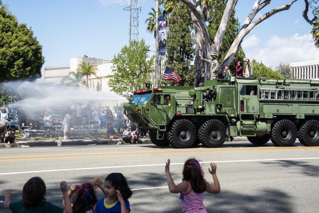Children of all ages cheered for the 163rd Ordnance Company's 1142 Tactical Fire Fighting Truck during the 57th Annual Torrance Armed Forces Day Parade, May 21, 2016. The 1142 Tactical Fire Fighting Truck is ready to deploy in almost any terrain to combat five types of fires/hazards; wildland, structural (limited to two stories or less), petroleum, oils, lubricants, hazardous materials, tactical vehicle fires, and aircraft crashes.