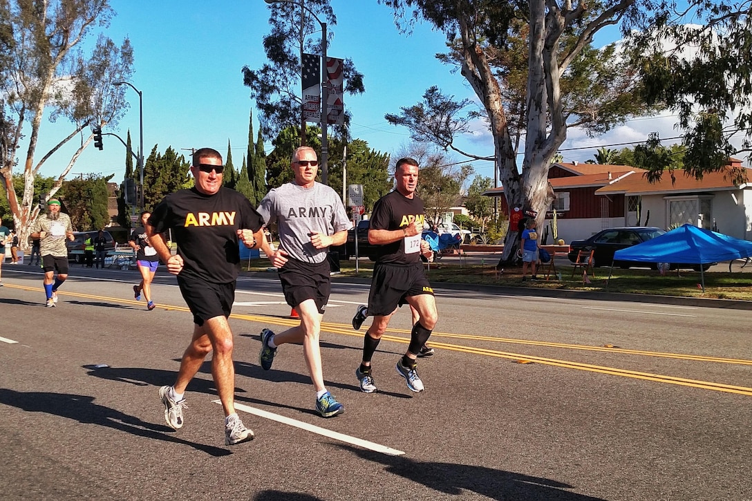 Maj. Gen. Mark Palzer, 79th SSC Commanding General (left), Brig. Gen. David Elwell, 311th ESC Commanding General (center), and Brig. Gen. Malcolm Frost, US Army Chief of Public Affairs (right), run in the Louis Zamperini Armed Forces Day 5K run in Torrance, Calif. May 21, 2016.