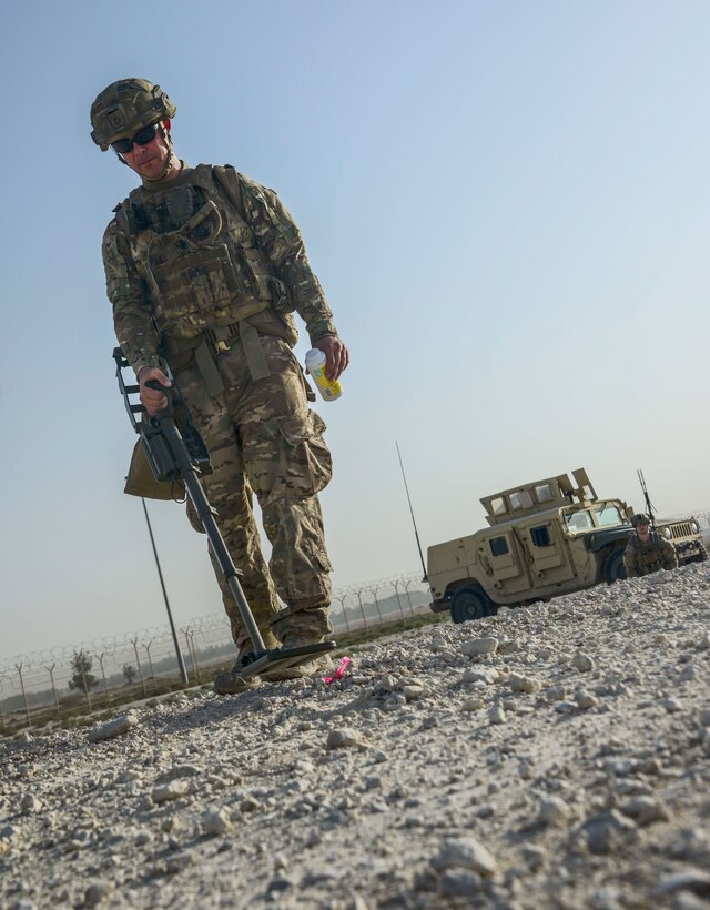 Tech. Sgt. Kelly Badger, a 379th Expeditionary Civil Engineer Squadron explosive ordnance disposal craftsman, uses a compact metal detector to interrogate an improvised explosive device he detected during a training exercise May 19, 2016, at Al Udeid Air Base, Qatar. Badger said he chose to join the Air Force, and more specifically EOD, to save lives, even if it meant putting his own at risk. (U.S. Air Force photo/Senior Airman Janelle Patiño)