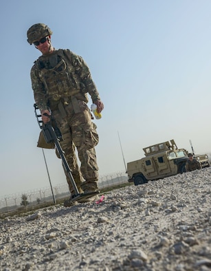 Tech. Sgt. Kelly Badger, a 379th Expeditionary Civil Engineer Squadron explosive ordnance disposal craftsman, uses a compact metal detector to interrogate an improvised explosive device he detected during a training exercise May 19, 2016, at Al Udeid Air Base, Qatar. Badger said he chose to join the Air Force, and more specifically EOD, to save lives, even if it meant putting his own at risk. (U.S. Air Force photo/Senior Airman Janelle Patiño)
