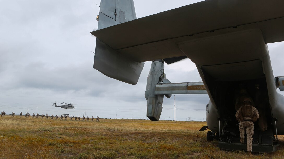 Marines with the 11th Marine Expeditionary Unit board an MV-22B Osprey and wait to board a CH-53E Super Stallion with Marine Medium Tiltrotor Squadron 163 (Reinforced) during a simulated raid on Marine Corps Base Camp Pendleton, Calif., May 17. Marines with VMM-163 (Rein.) supplied four MV-22B Ospreys, two AH-1W Cobras, two UH-1Y Hueys and one CH-53E Super Stallion to support a simulated raid.
