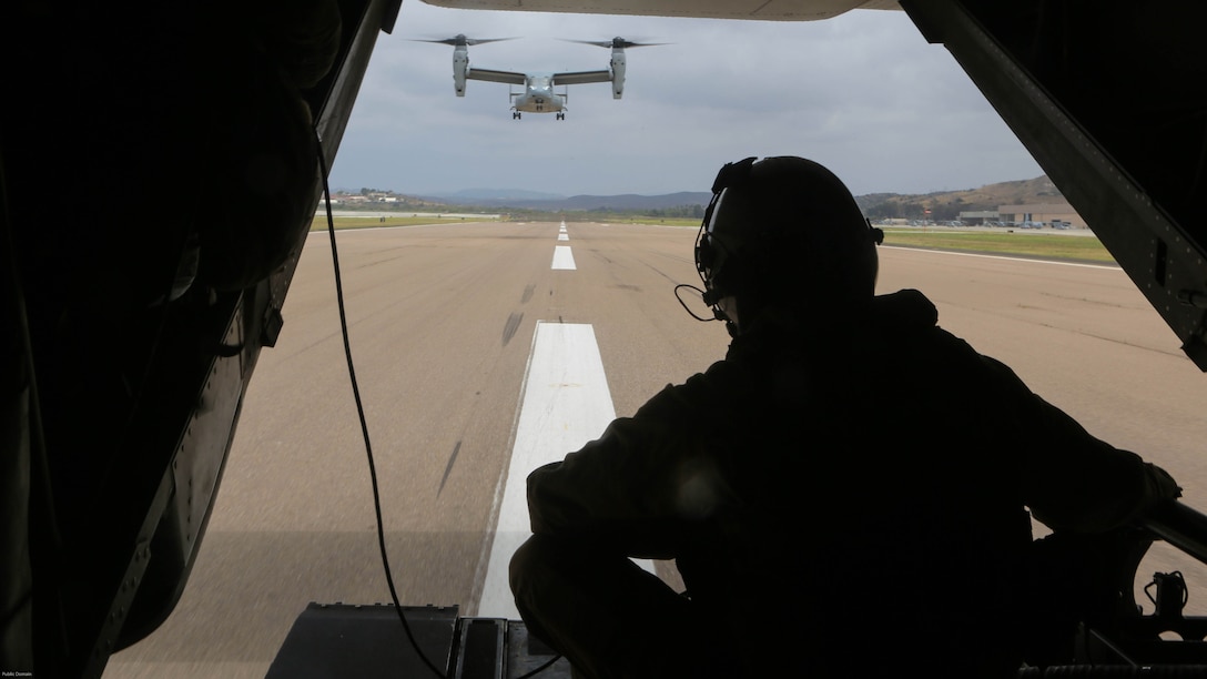 Cpl. Matthew Maenner, crew chief with Marine Medium Tiltrotor Squadron 163 (Reinforced) observes the other MV-22B Osprey returning from Marine Corps Base Camp Pendleton and landing aboard Marine Corps Air Station Miramar, Calif., May 17. Marines with VMM0-163 (Rein.) supported the 11th Marine Expeditionary Unit during a simulated raid and supplied four MV-22B Ospreys, two AH-1W Cobras, two UH-1Y Hueys and one CH-53E Super Stallion. 