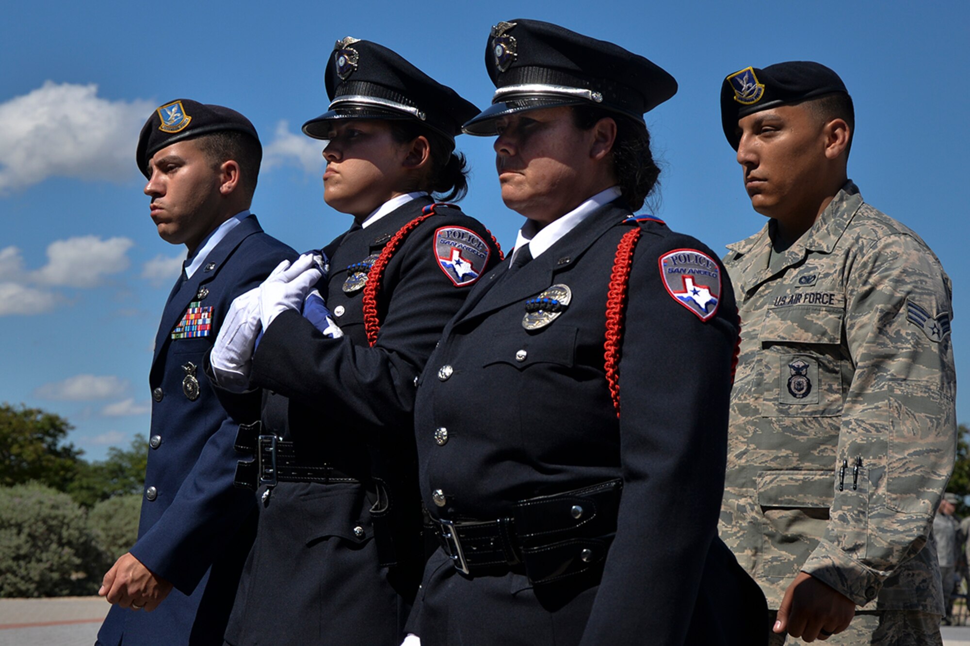 17th Security Forces Squadron Airmen and San Angelo law enforcement officers carry the nation’s flag on Goodfellow Air Force Base, Texas, May 20, 2016. The 17th SFS flew the flag over Goodfellow in honor of Law Enforcement officers that had fallen in the line of duty. The 17th SFS performed the ceremony to celebrate National Police Week, an annual event that honors all fallen police officers. (U.S. Air Force photo by Airman 1st Class Randall Moose/Released)