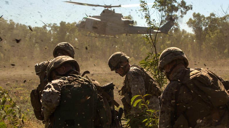Marines endure light debris from a UH-1Y Venom helicopter at a landing zone outside of Robertson Barracks, Northern Territory, Australia, on May 20, 2016. Marines with Marine Rotational Force - Darwin simulated causality evacuations with a UH-1Y Venom helicopter. MRF-D is a six-month deployment of Marines into Darwin, Australia, training in a new environment. 