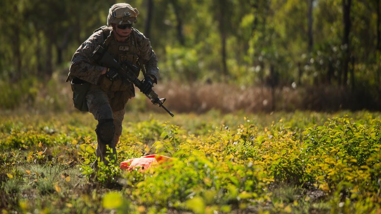 Lance Cpl. Karl-Andrew Perkins, a rifleman, places an air panel to signal a UH-1Y Venom helicopter to a landing zone outside of Robertson Barracks, Northern Territory, Australia, on May 20, 2016. Marines with Marine Rotational Force - Darwin simulated causality evacuations with a UH-1Y Venom helicopter. MRF-D is a six-month deployment of Marines into Darwin, Australia, training in a new environment. Perkins, from Grove City, Pennsylvania, is with Company B, 1st Battalion, 1st Marine Regiment, MRF-D.