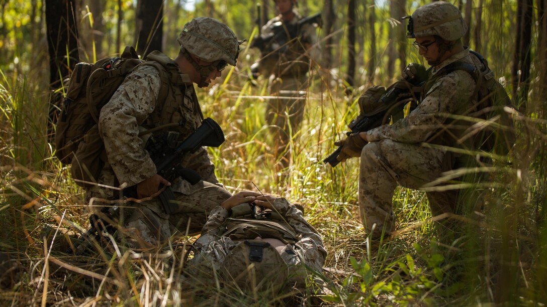 U.S. Marine riflemen provide field care to a simulated casualty in a training area outside of Robertson Barracks, Northern Territory, Australia, on May 20, 2016. Marines with Marine Rotational Force - Darwin simulated causality evacuations with a UH-1Y Venom helicopter. MRF-D is a six-month deployment of Marines into Darwin, Australia, training in a new environment. 