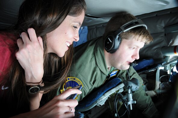 Congressional staffer Chelsea Cuellar and a boom operator with the 756th Air Refueling Squadron look out the window of a boom pod during the refueling of a 1st Fighter Wing F-22 Raptor May 20. The 459th Air Refueling Wing flew a congressional delegation from Moody Air Force Base, Ga., where they witnessed an air power demonstration, back to the National Capital Region. On the return leg, the distinguished travelers were able to witness the in-flight refueling. (U.S. Air Force photo/Staff Sgt. Kat Justen)