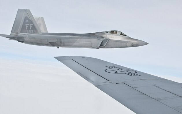 A 1st Fighter Wing F-22 Raptor is seen flying off the wingtip of a 459th Air Refueling Wing KC-135R Stratotanker after the two aircraft conducted an in-flight refueling. The 459th flew a congressional delegation from Moody Air Force Base, Ga., where they witnessed an air power demonstration, back to the National Capital Region. On the return leg, the distinguished travelers were able to witness the in-flight refueling. (U.S. Air Force photo/Staff Sgt. Kat Justen)