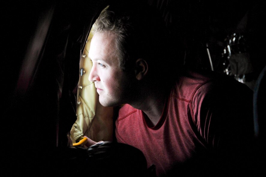 Congressional staffer JT Mackey looks out the window of a 459th Air Refueling Wing KC-135R Stratotanker at a 1st Fighter Wing F-22 Raptor mid-flight May 20. The 459th flew a congressional delegation from Moody Air Force Base, Ga., where they witnessed an air power demonstration, back to the National Capital Region. On the return leg, the distinguished travelers were able to witness an in-flight refueling of the F-22. (U.S. Air Force photo/Staff Sgt. Kat Justen)